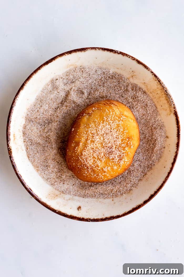 Filling Pumpkin Spice Bomboloni with cinnamon custard