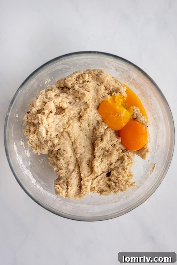 Adding egg yolks to Bomboloni dough