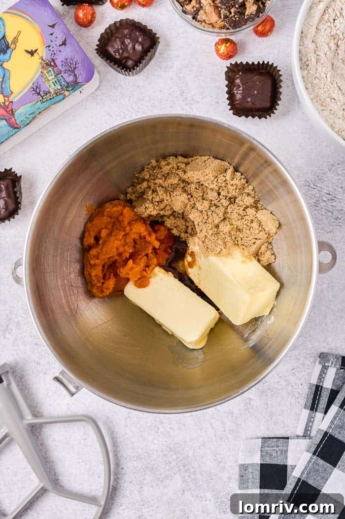 Dry ingredients being gradually added to the wet mixture in a stand mixer set to medium-low speed for cookie dough.