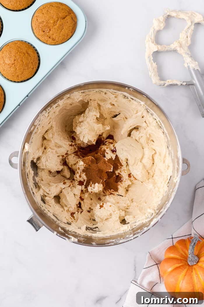 Brown sugar swiss meringue buttercream being prepared and flavored with vanilla and cinnamon