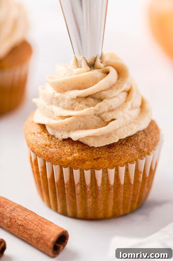 Beautifully frosted pumpkin spice cupcakes with brown sugar frosting on a tiered stand