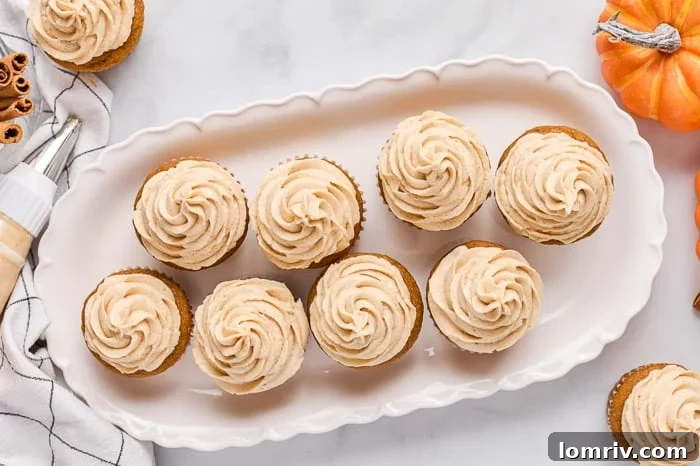 A close-up shot of freshly baked pumpkin cupcakes ready for frosting