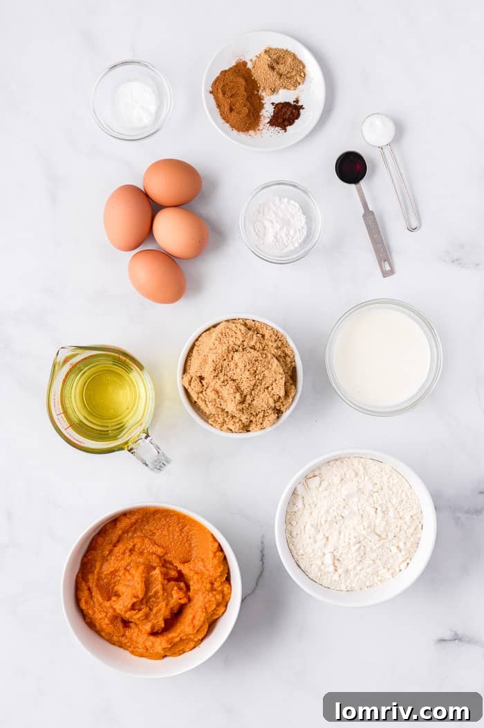Pumpkin cupcake batter being scooped into cupcake liners