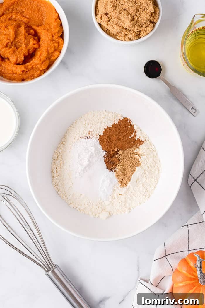 Dry ingredients for pumpkin cupcakes being whisked in a bowl