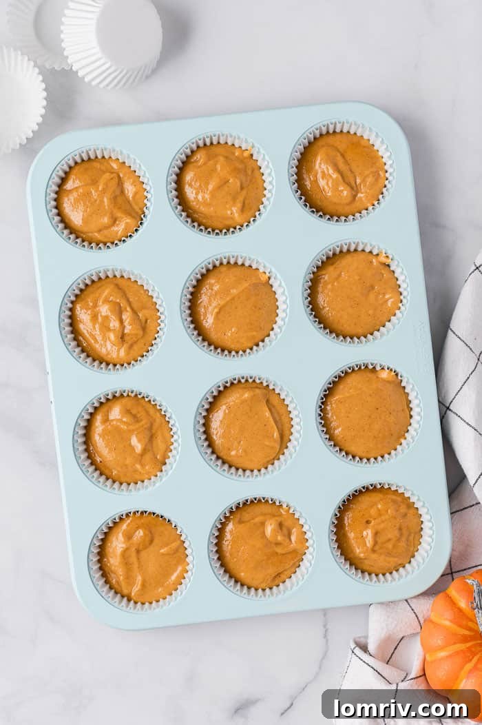 Freshly baked pumpkin cupcakes cooling on a wire rack