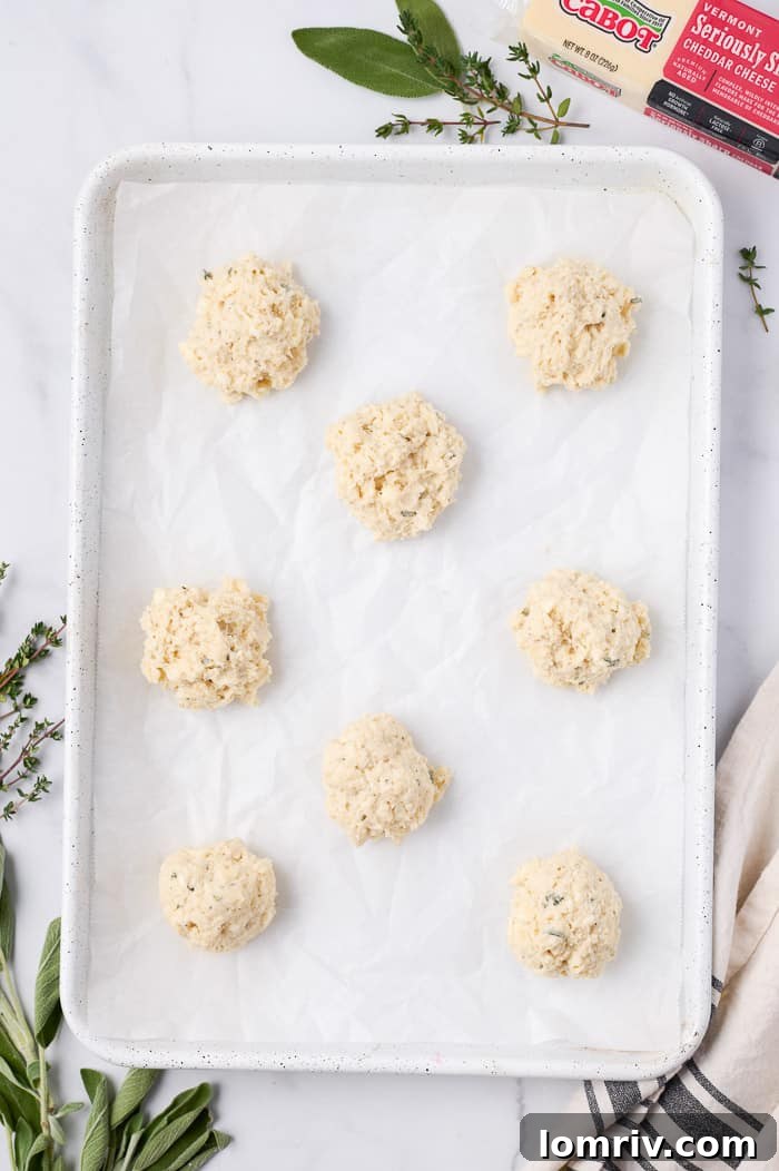 Raw Cheddar Biscuit Dough on Parchment Paper