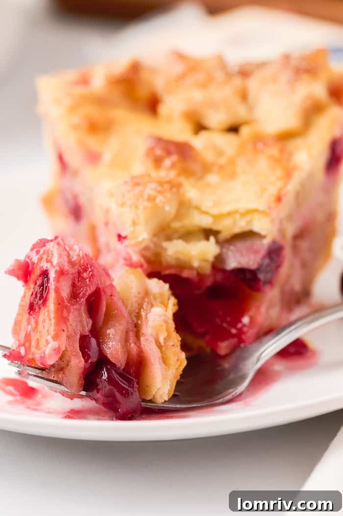 An assembled pie with the top crust lattice design visible, ready for baking