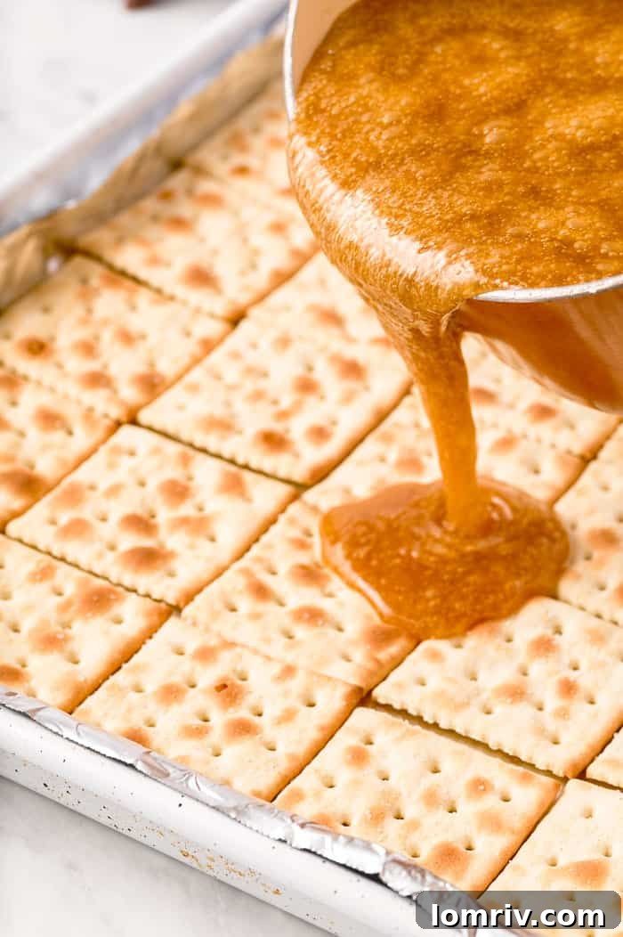 Toffee mixture poured over saltine crackers