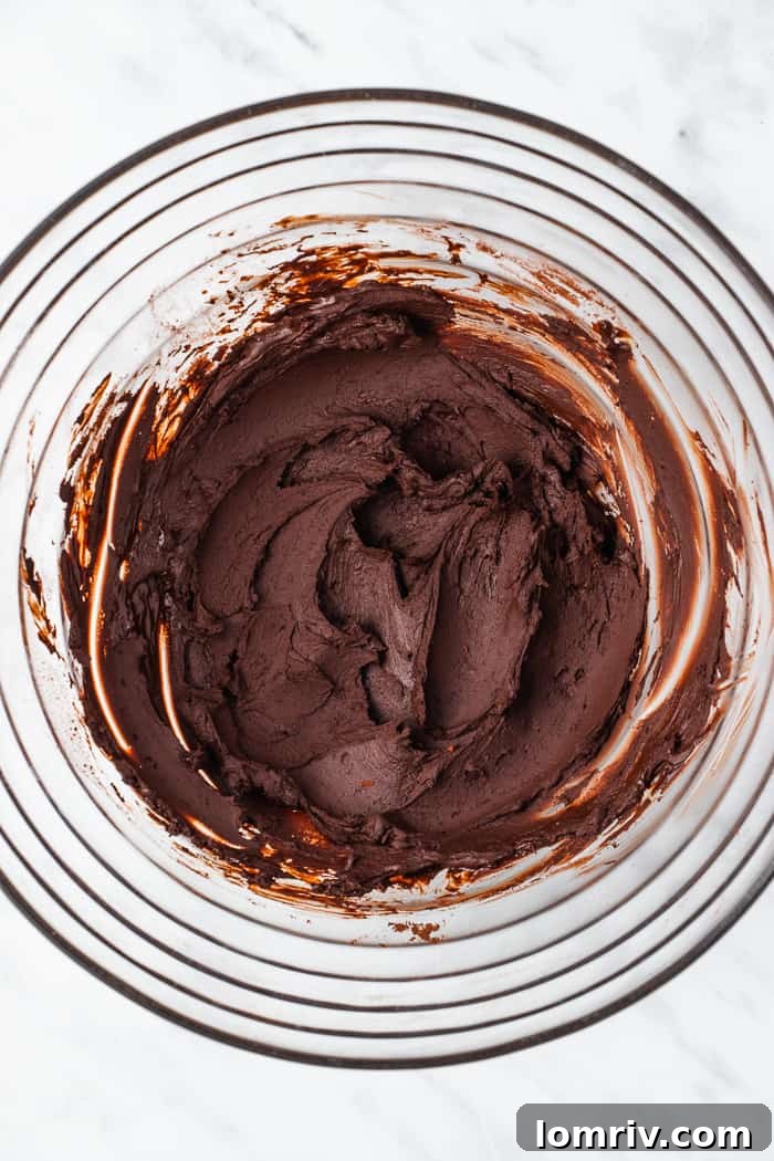 Mixing cocoa powder with boiling water into a paste