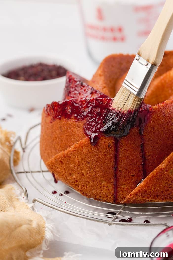 Final Fonio Pound Cake with a smooth, shiny hibiscus glaze poured over it