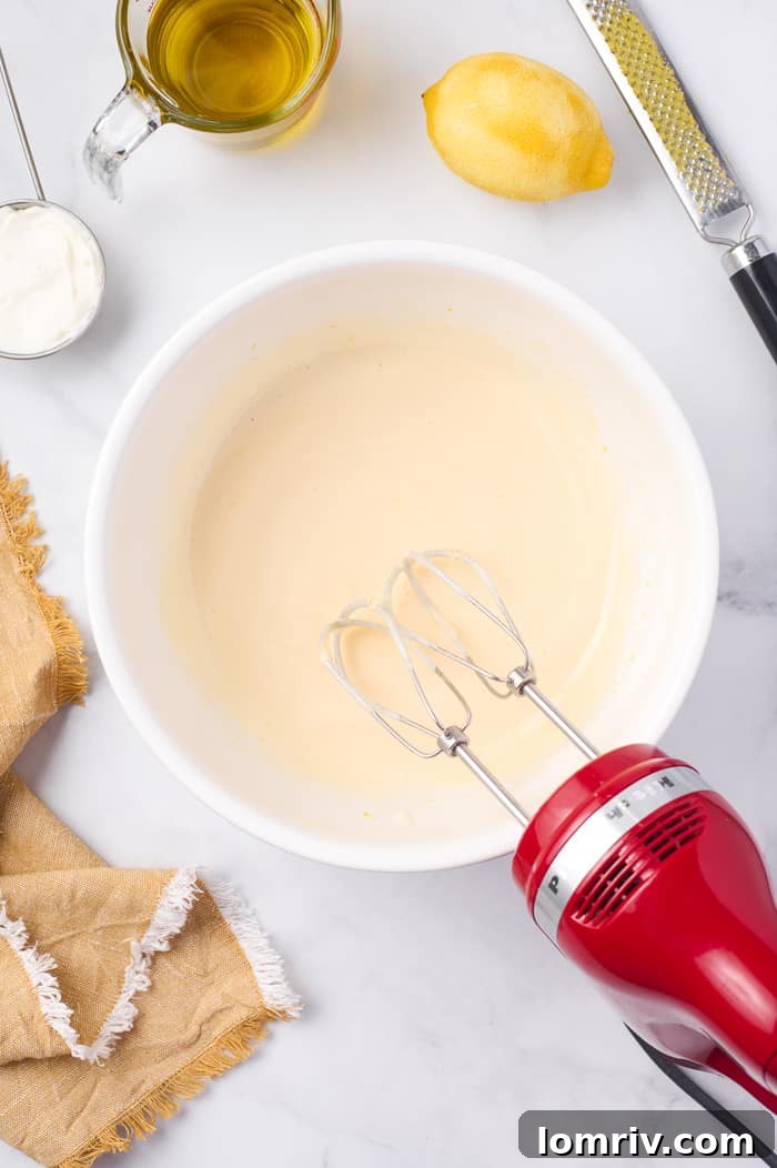 Fonio Pound Cake batter poured into an ornate bundt pan, ready for baking