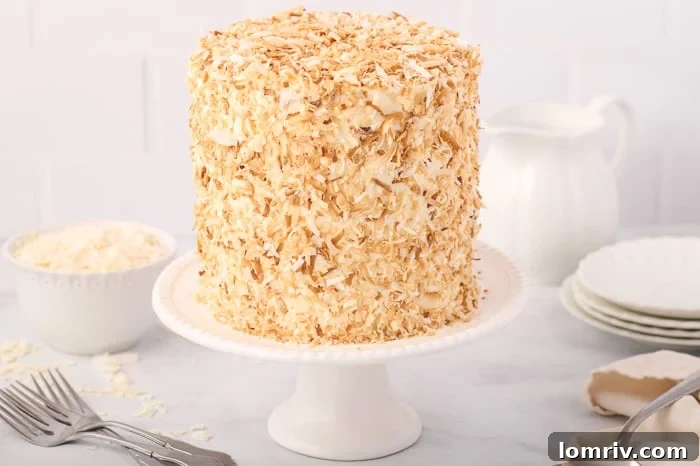 Slice of Tropical Coconut Layer Cake with Creamy Frosting