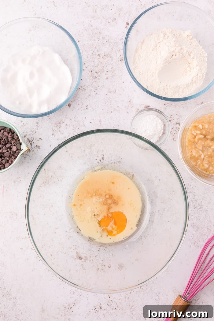 Mixing wet ingredients in a bowl for banana chocolate chip muffins