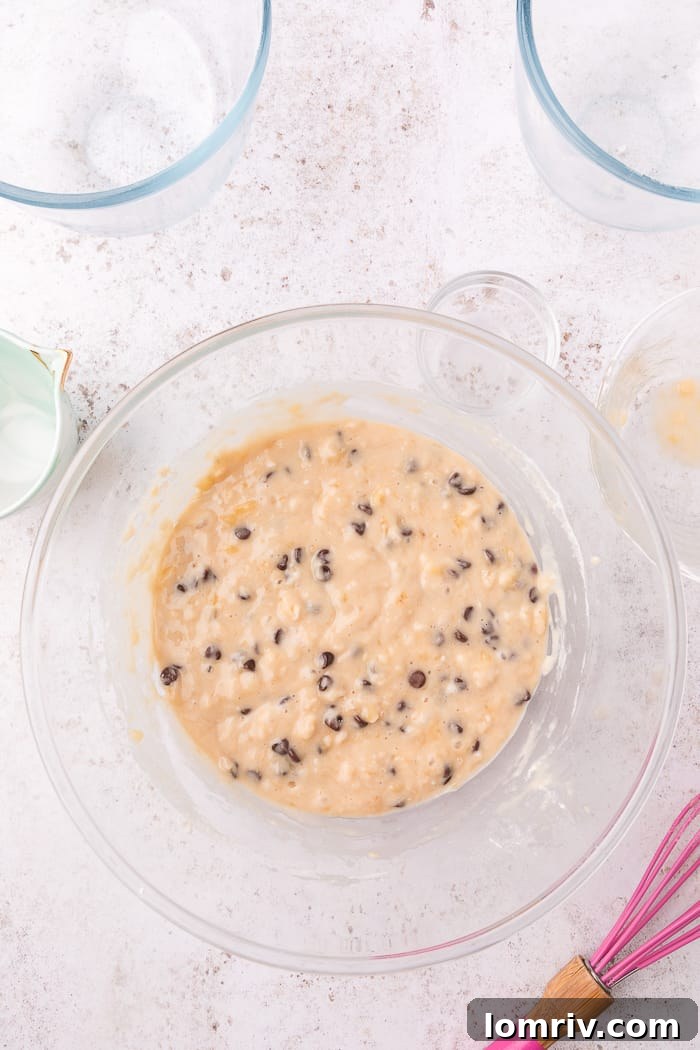 Folding chocolate chips into banana muffin batter