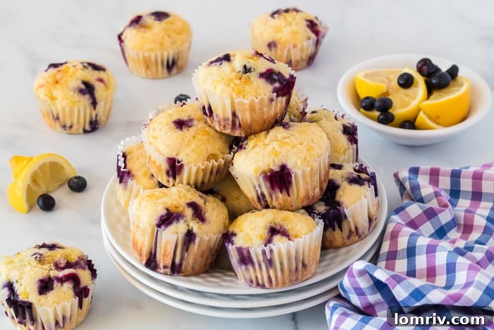 A close-up of a stack of fluffy Lemon Blueberry Muffins