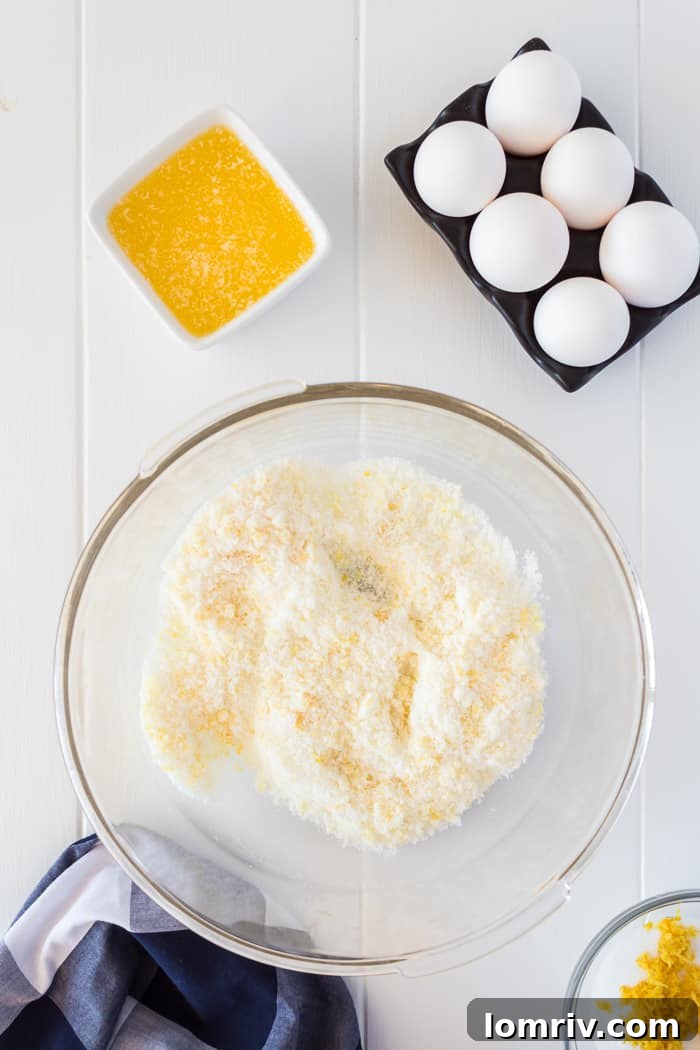 Melted butter being whisked into lemon-infused sugar