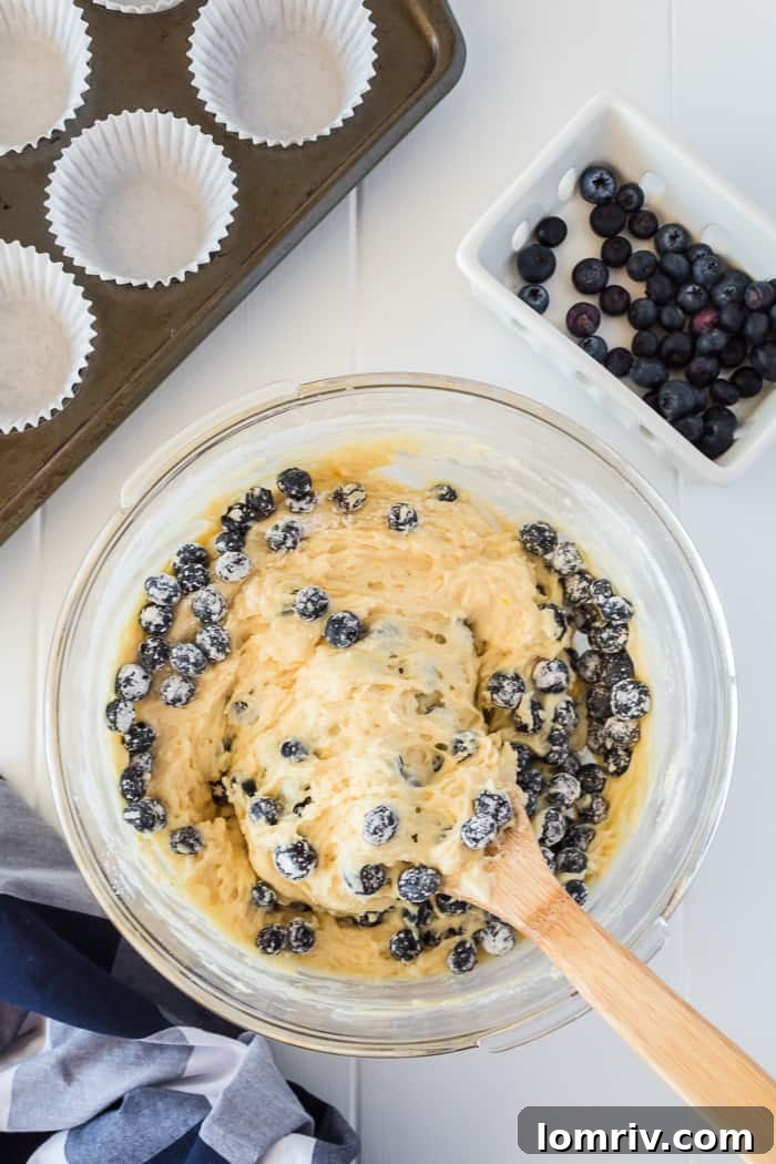 Muffin tin filled with batter and sprinkled with lemon sugar topping