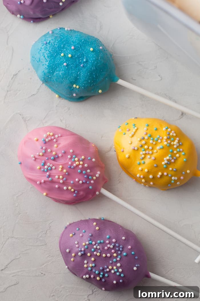 A collection of undecorated Easter Cake Pops in egg shapes, ready for dipping and decorating.