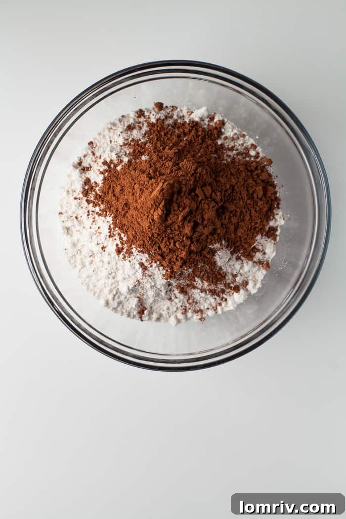 Dry ingredients for the chocolate cake, including flour and cocoa powder, prepared in a bowl.