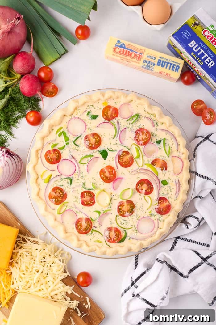 Quiche fully assembled with egg mixture and vegetables, ready for baking