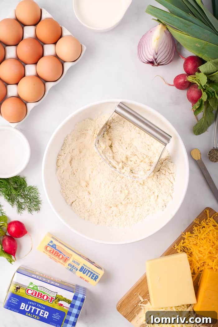 Cutting cold Cabot butter into flour for the quiche crust