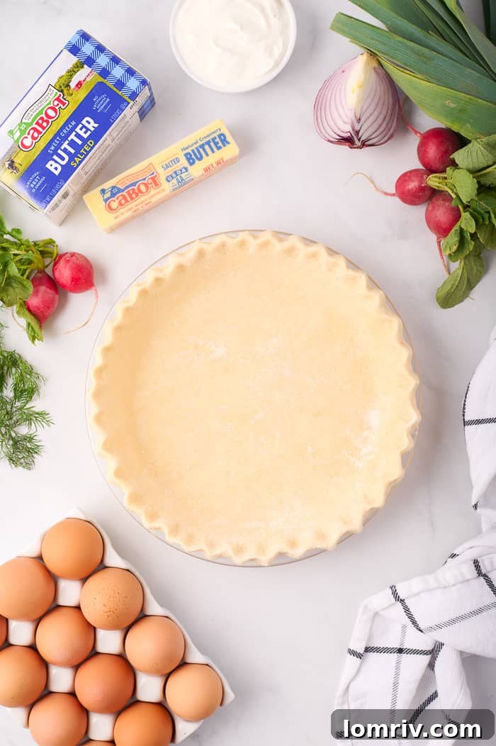 Rolling out quiche dough and placing it into a pie dish