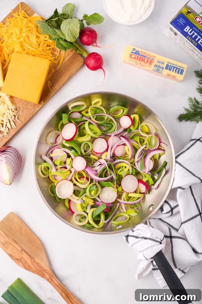 Sautéing spring vegetables (leeks, onions, radishes) for the quiche filling