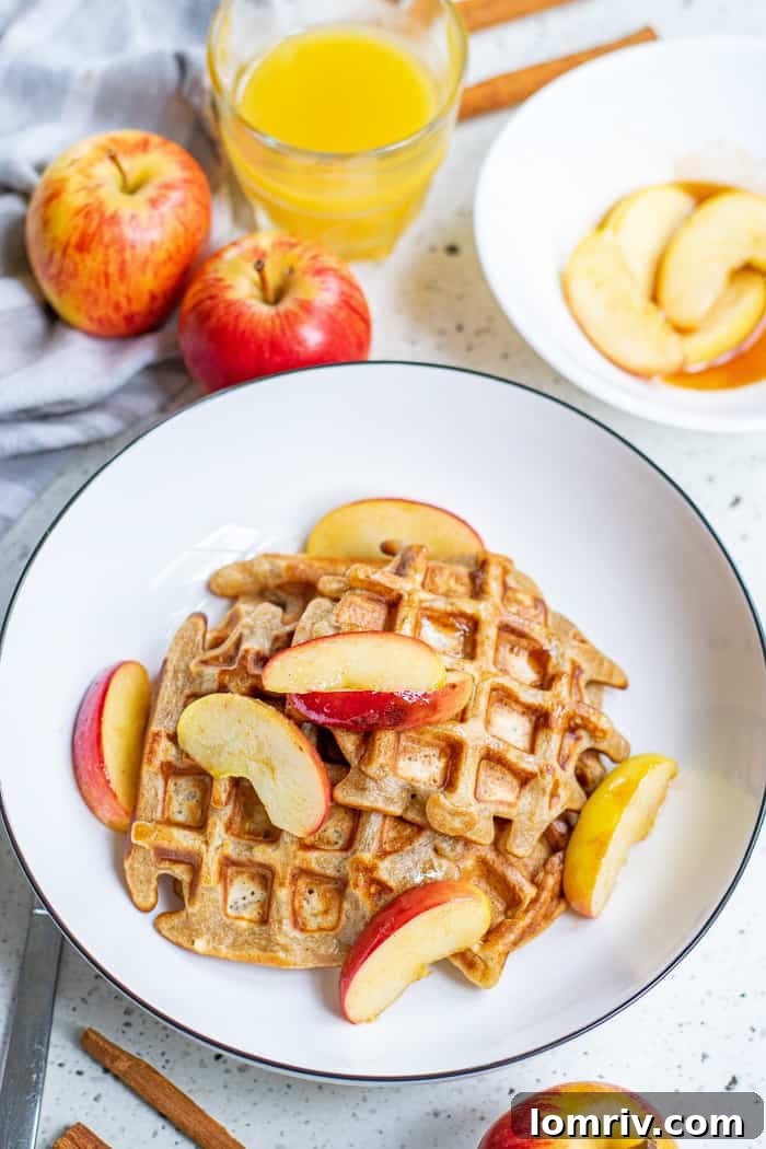 Delicious Apple Cinnamon Waffles Stacked with Syrup