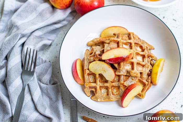 Close-up of fluffy Apple Cinnamon Waffles on a plate