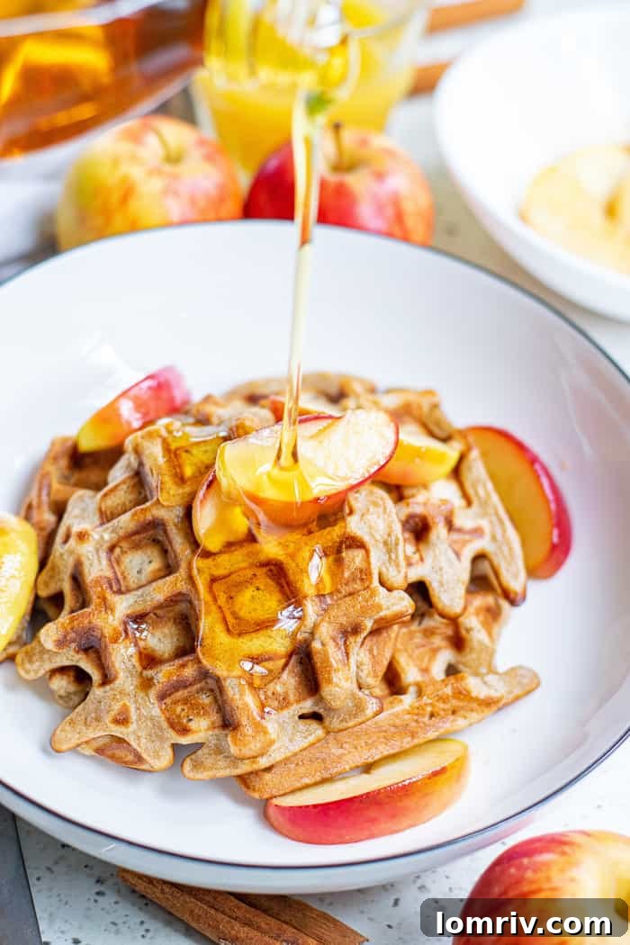 Top-down view of Apple Cinnamon Waffles with butter and syrup