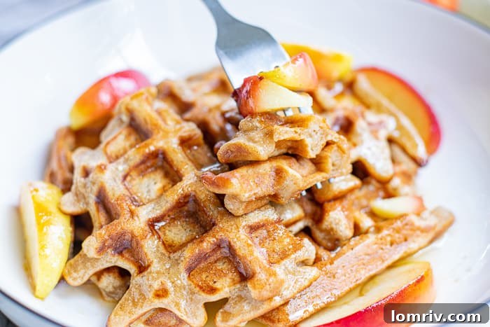 Golden-brown Apple Cinnamon Waffles on a cooling rack