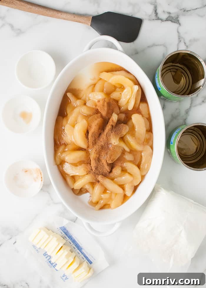 Combining apple pie filling with spices and lemon juice in a baking dish.