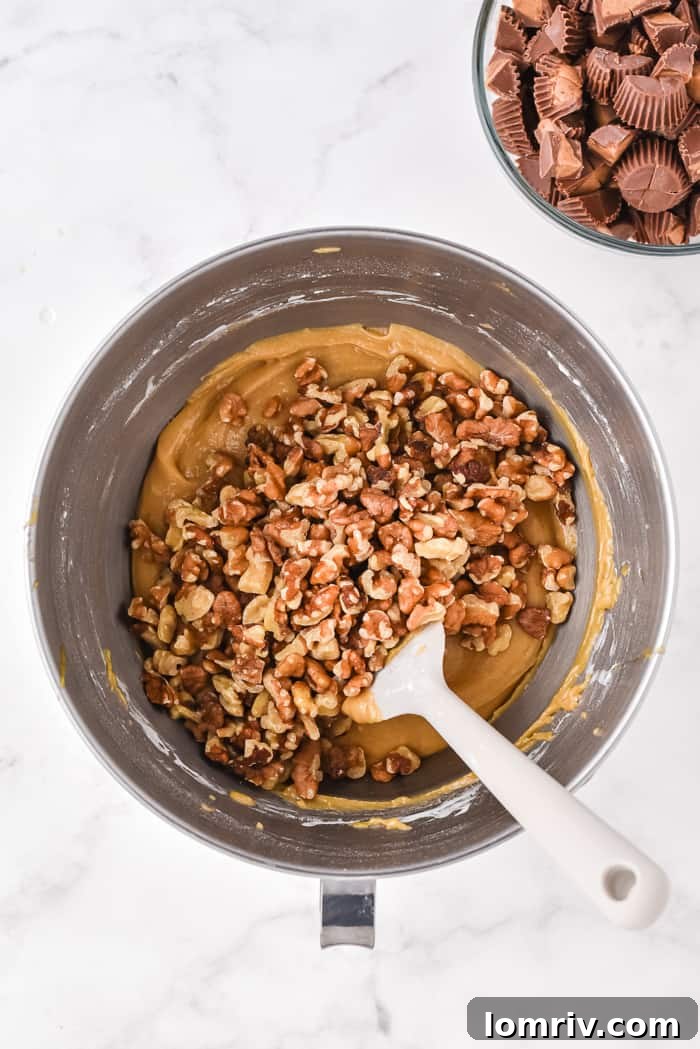 Folding Walnuts and Reese's into Blondie Batter