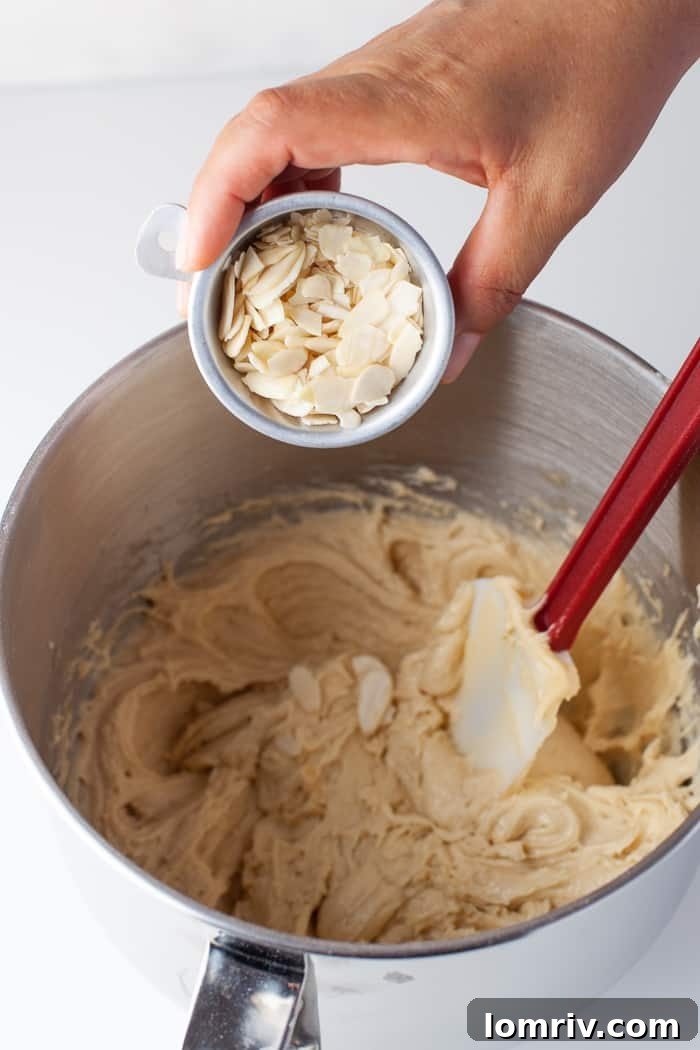 Folding sliced almonds into blondie batter