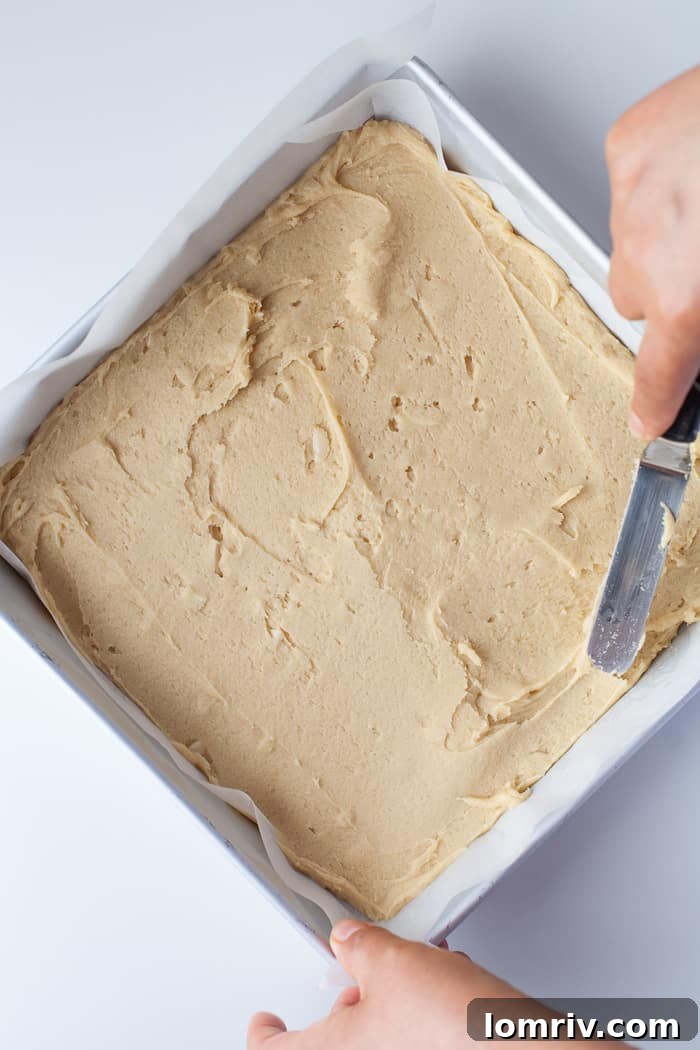 Spreading blondie batter into a baking pan