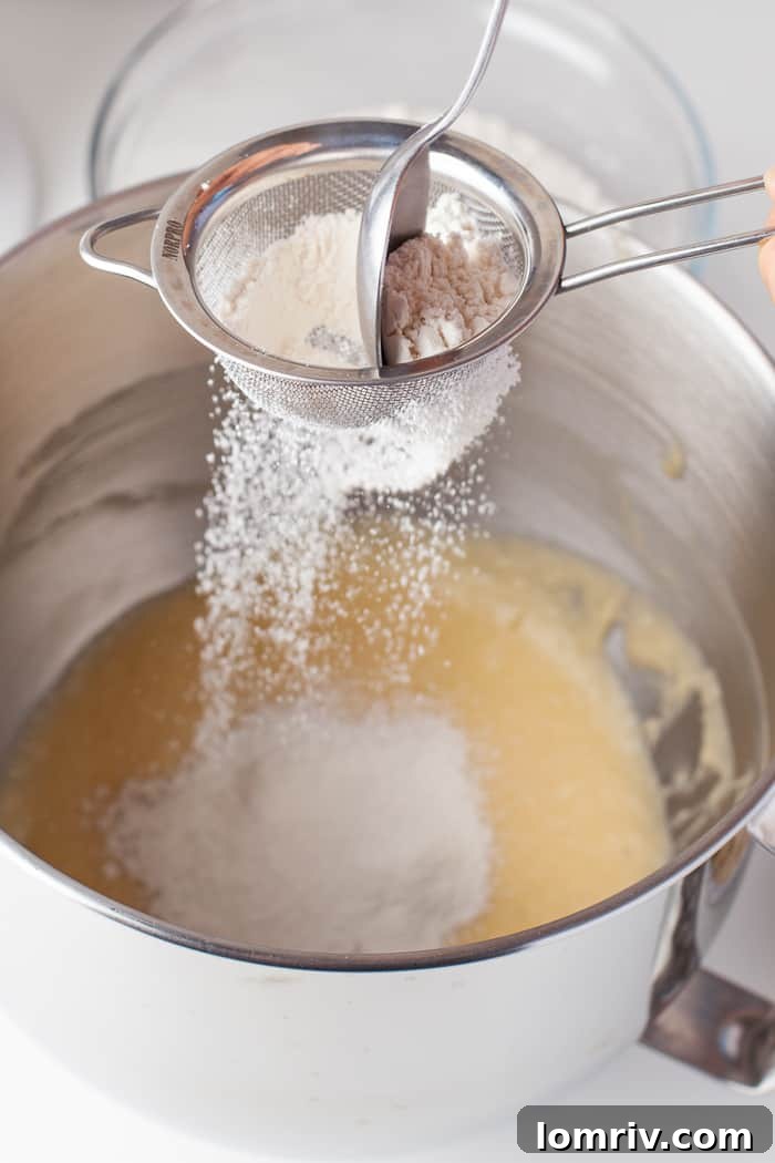 Sifting flour into blondie batter