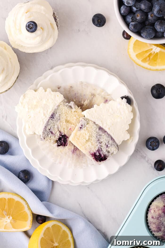 Close-up of a Lemon Blueberry Cupcake with a bite taken out, showing compote