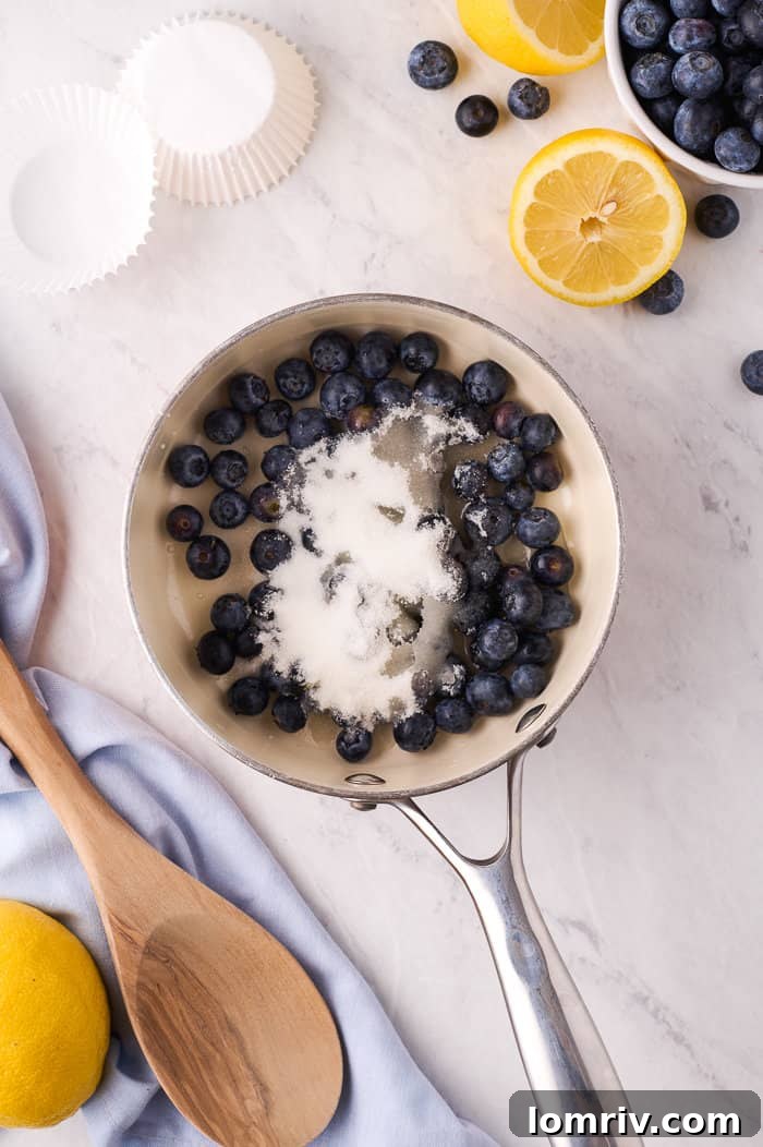Blueberries simmering for compote in a saucepan
