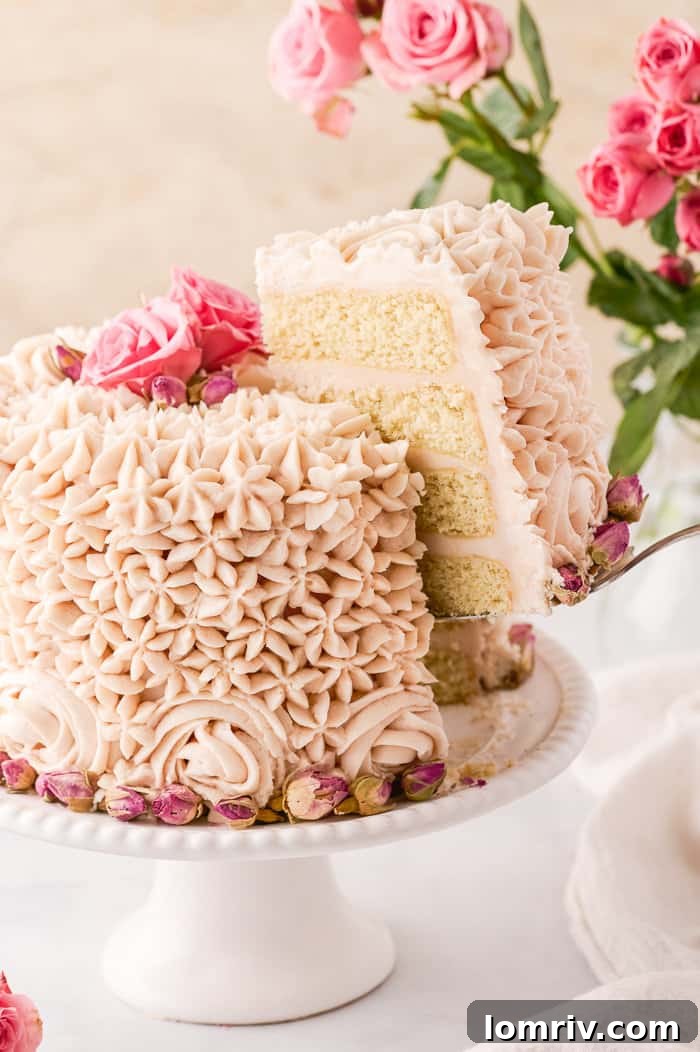 Slice of Vanilla Rose Cake showing moist layers and creamy rose buttercream.