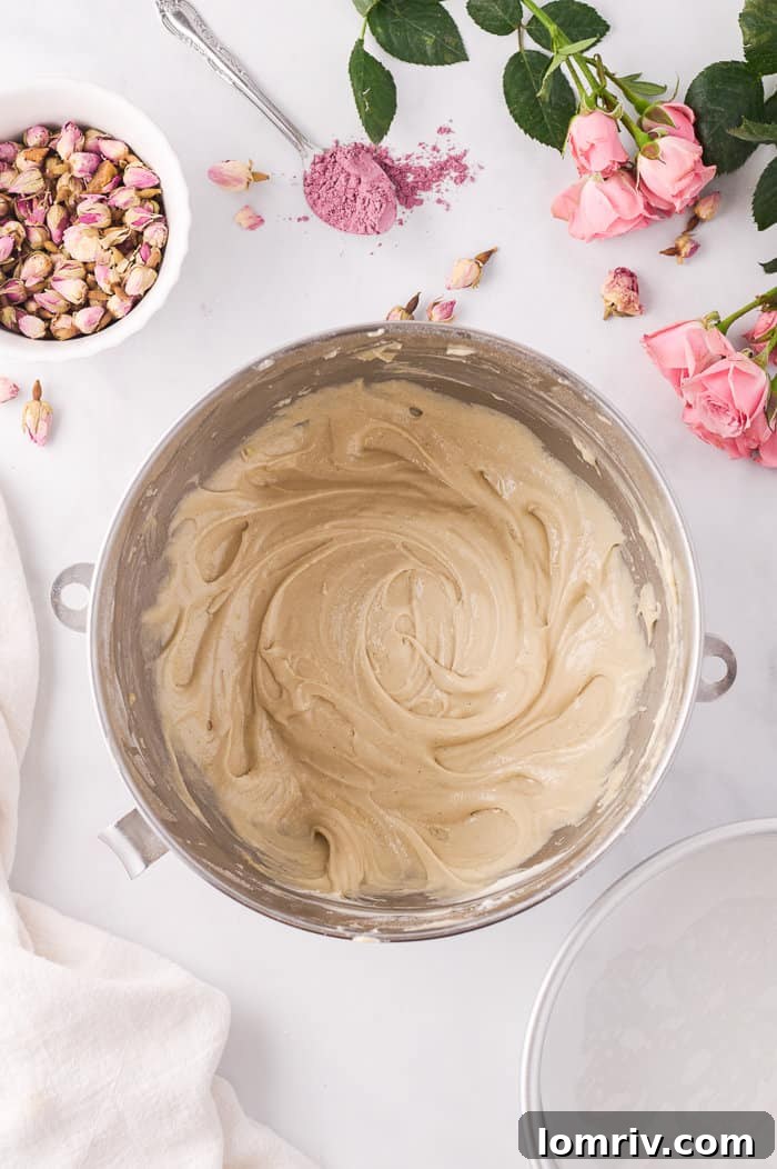 Cake batter divided into pans.