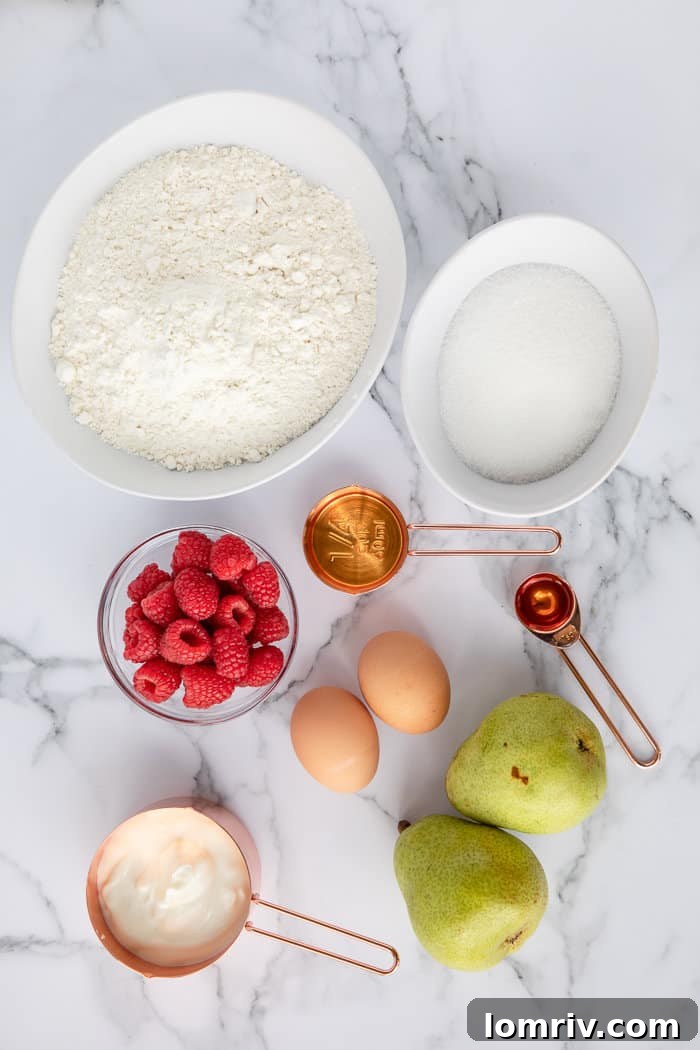 All the dry and wet ingredients for Pear and Raspberry Bread laid out in separate bowls on a marble surface.