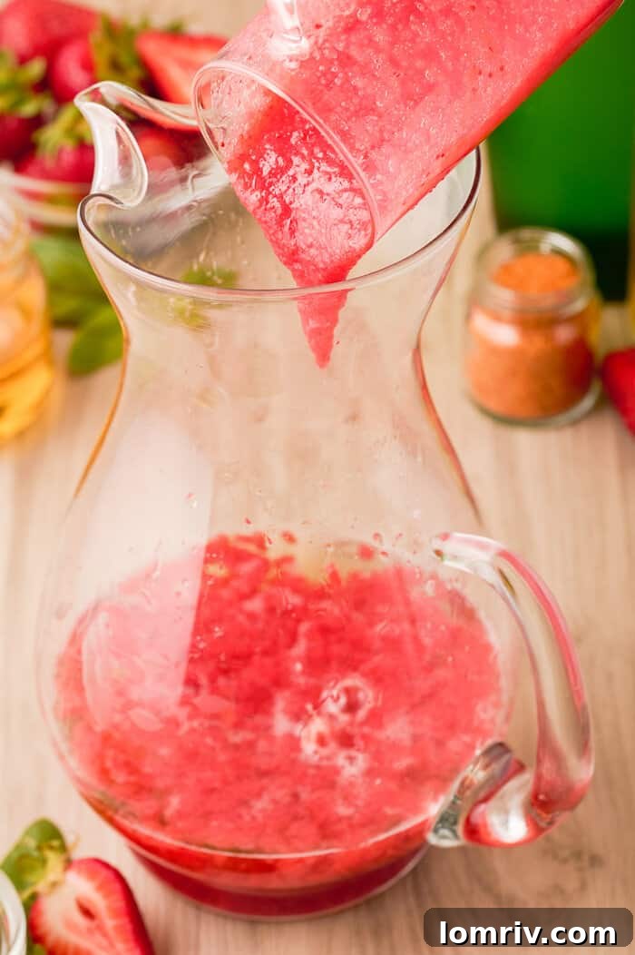 Step-by-step image of mixing ingredients in a pitcher for Strawberry Paloma