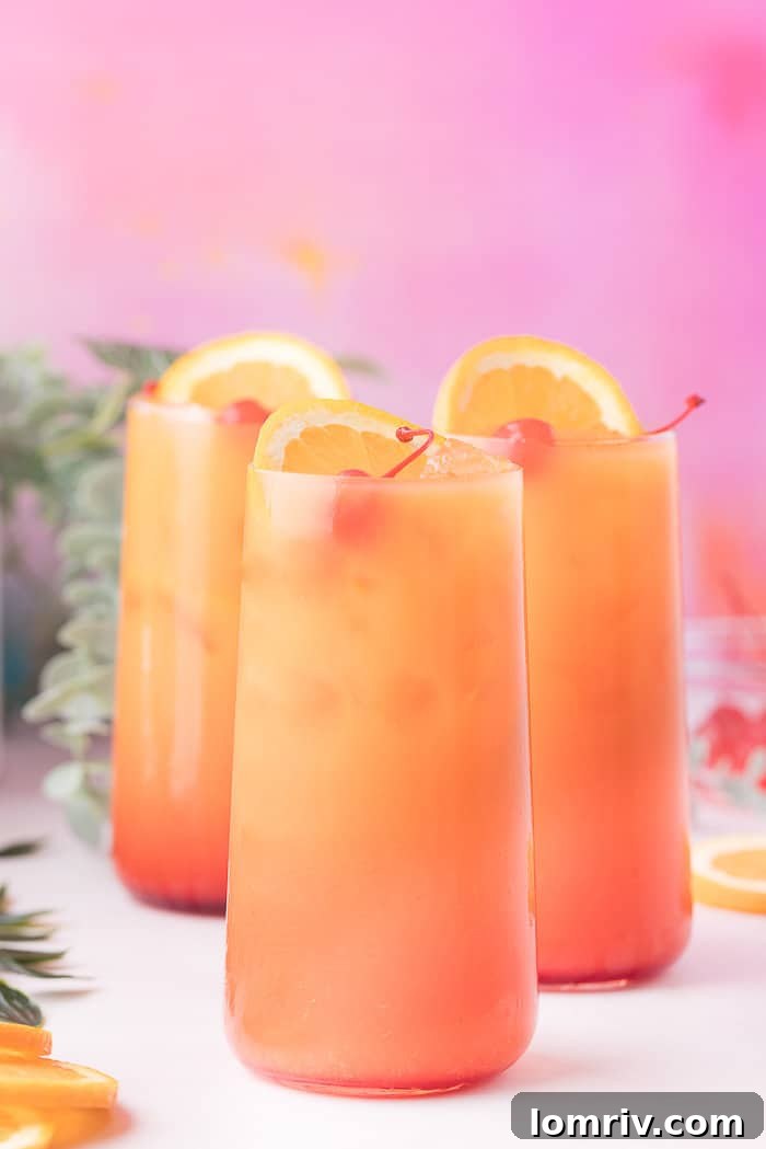 Three exquisite Tequila Sunrise cocktails presented side-by-side, showcasing their vibrant colors.