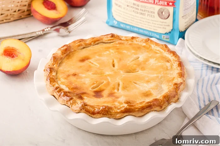 Close-up of a slice of Fresh Peach Pie, showcasing tender flaky crust and rich peach filling