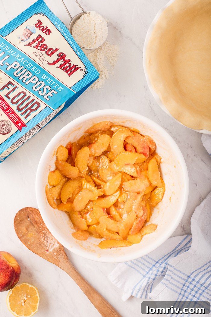 Unbaked Fresh Peach Pie with a perfectly crimped crust, ready for the oven