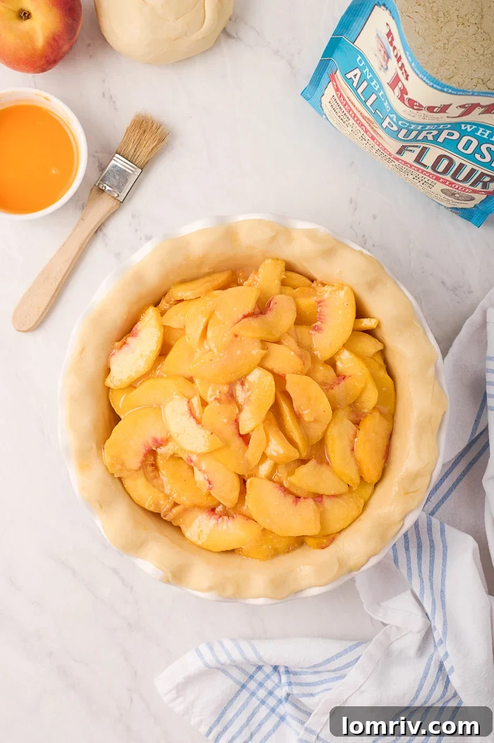 Golden-brown Fresh Peach Pie fresh out of the oven, with bubbly filling