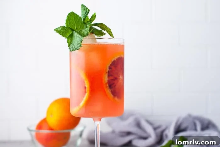 Three glasses of Blood Orange Mezcal Cocktails with blood orange slices.