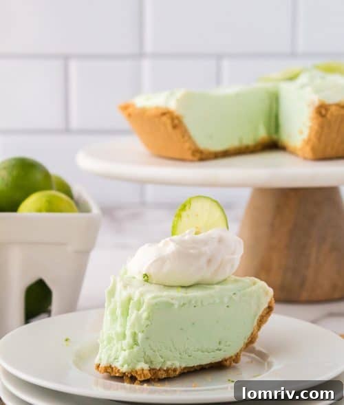 A vibrant slice of No Bake Key Lime Pie served on a simple white plate, ready to be enjoyed.