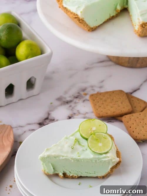 A close-up shot of a slice of No Bake Key Lime Pie, highlighting its smooth, creamy texture and vibrant color.