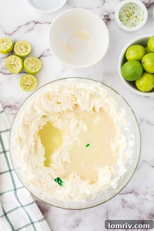 The creamy, green No Bake Key Lime Pie filling being mixed in a bowl, showing its smooth and inviting texture before being poured into the crust.